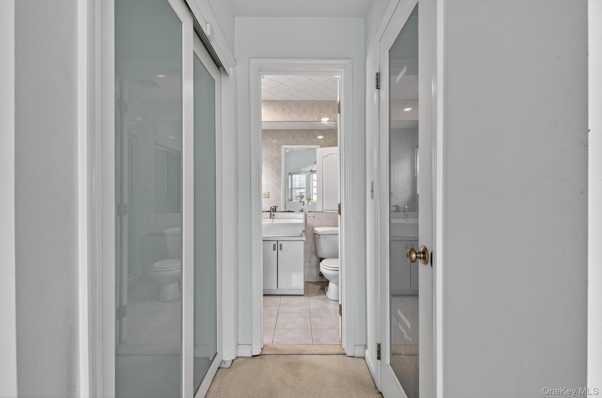 82 B Inwood Road Port Washington, NY 11050 - Photo 20 of 41 a view of a bathroom from a hallway