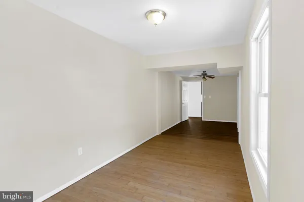 a view of an empty room with wooden floor