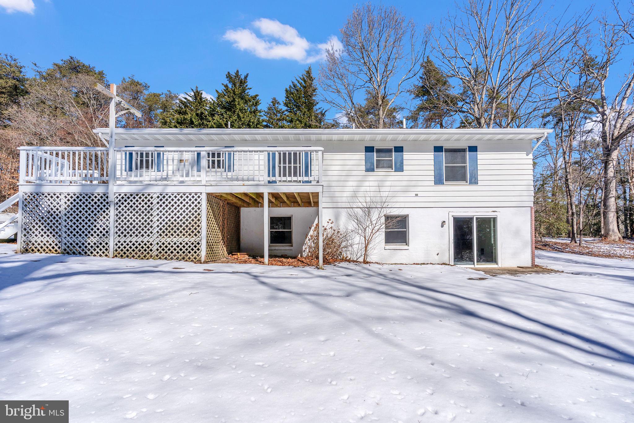 1150 Calvert Beach Road St. Leonard, MD 20685 - Photo 2 of 42 a front view of a house with a garden