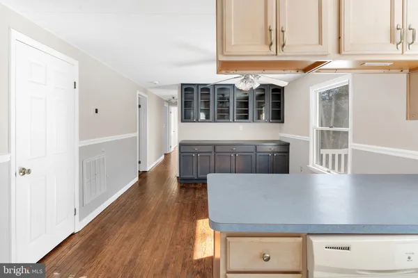 a kitchen with stainless steel appliances a refrigerator and wooden cabinets