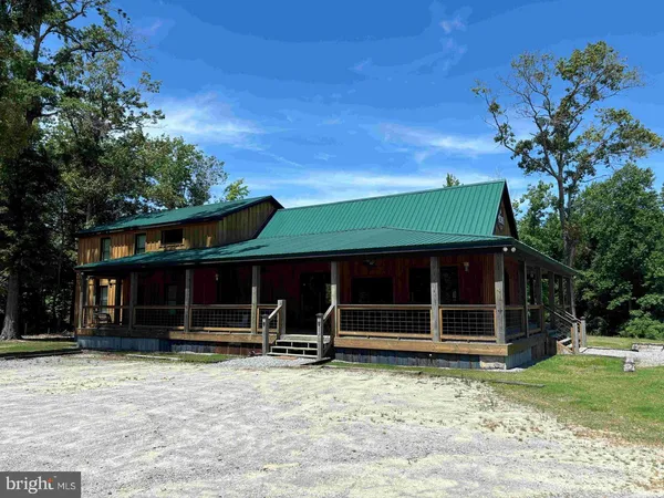 a view of a house with a yard and tree