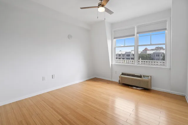 a bathroom with a granite countertop sink toilet and a mirror