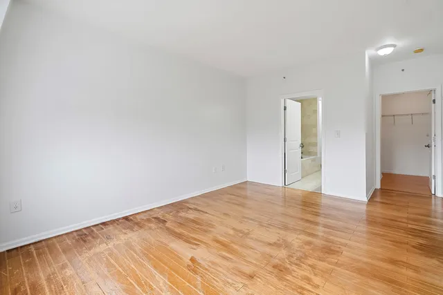 a bathroom with a granite countertop sink a large mirror and a shower