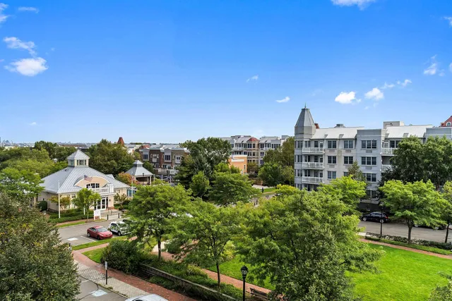 a living room with couches and a flat screen tv with wooden floor