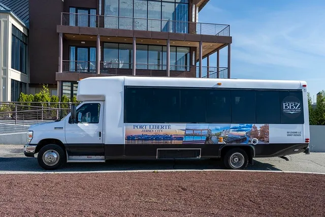 a front view of a residential apartment building with a yard and balcony