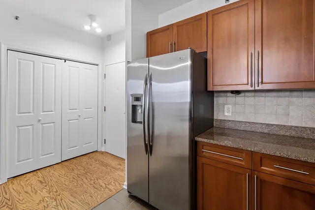 a kitchen with granite countertop a sink and cabinets