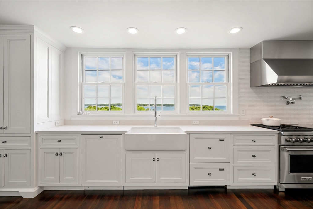 169 S Road Bourne, MA 02559 - Photo 17 of 42 a kitchen with granite countertop a stove a sink and a microwave