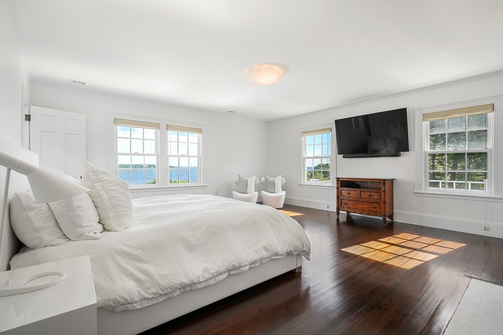 169 S Road Bourne, MA 02559 - Photo 23 of 42 a spacious bedroom with a bed and a flat screen tv
