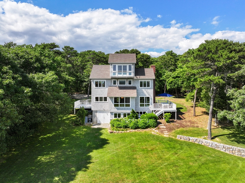 169 S Road Bourne, MA 02559 - Photo 33 of 42 a view of a house with a big yard plants and large trees