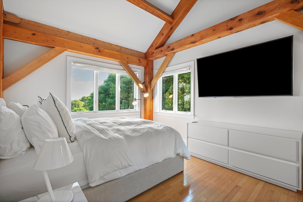 169 S Road Bourne, MA 02559 - Photo 37 of 42 a bedroom with a bed and a flat tv screen on dresser