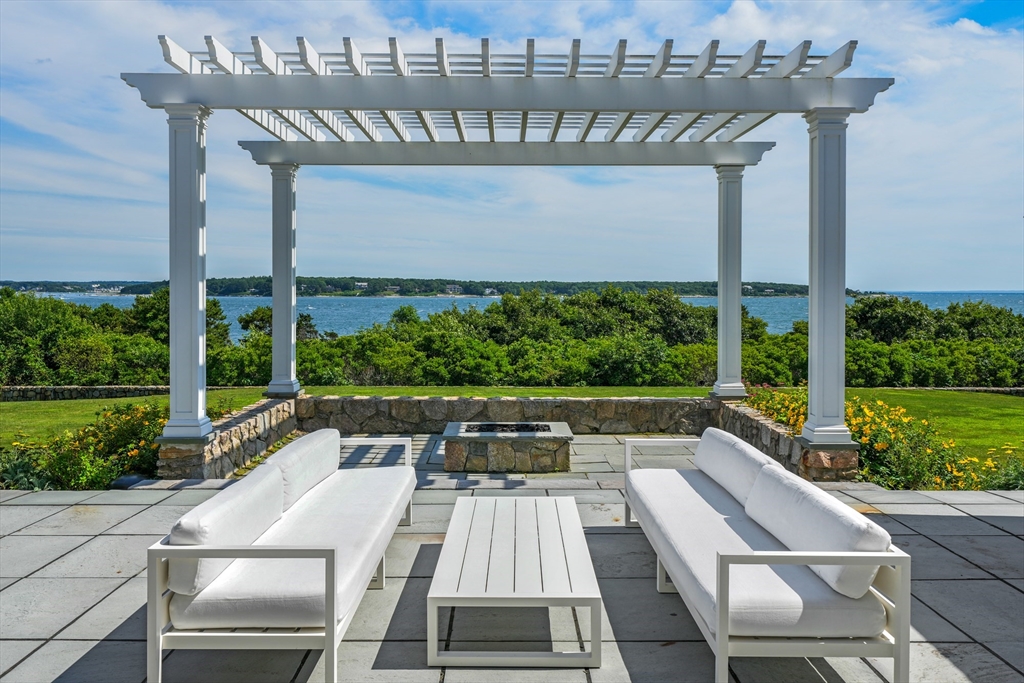169 S Road Bourne, MA 02559 - Photo 5 of 42 a view of a patio with table and chairs and potted plants
