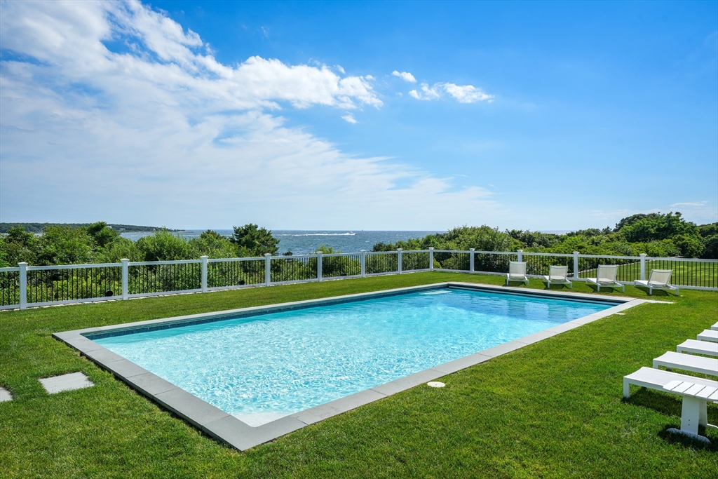 169 S Road Bourne, MA 02559 - Photo 7 of 42 a view of a swimming pool with a yard