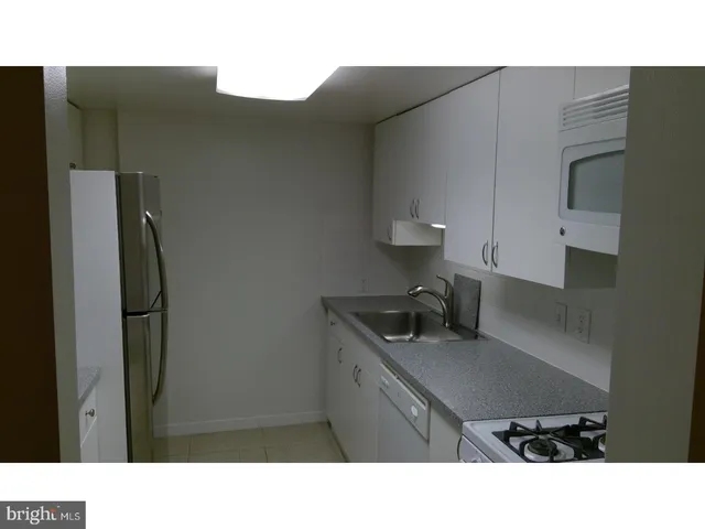 a kitchen with cabinets and appliances