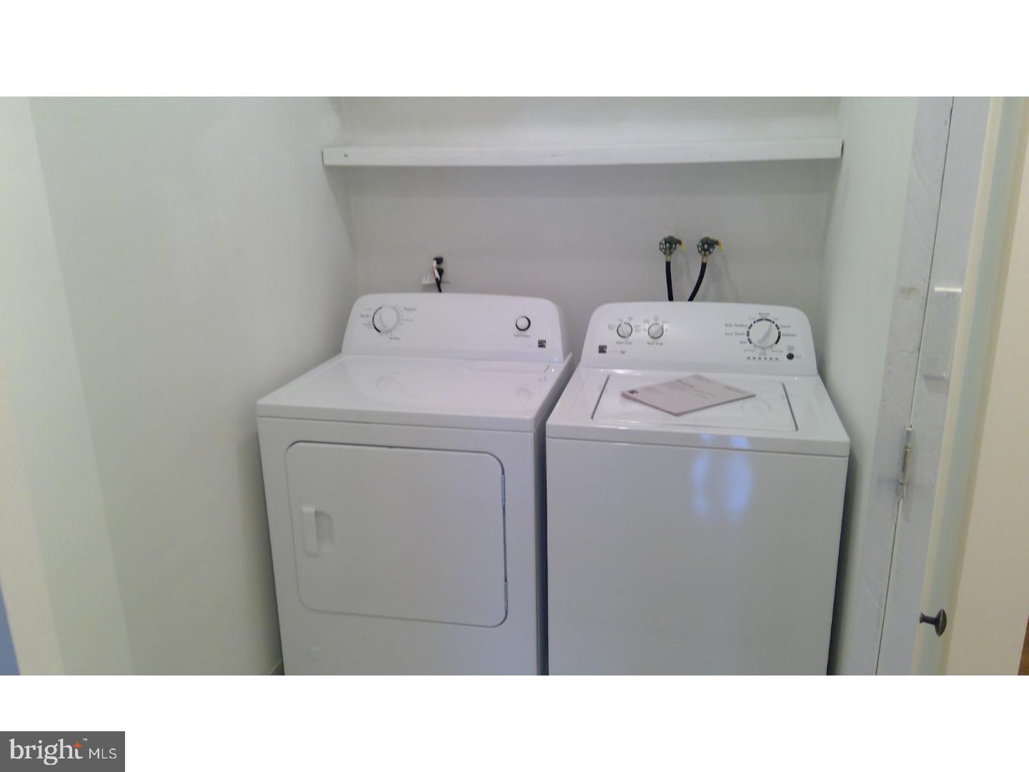 379 Old Forge Crossing Devon, PA 19333 - Photo 8 of 15 a open kitchen with dryer and washer