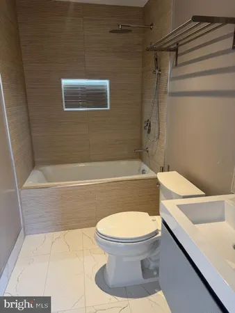 a bathroom with a toilet a sink and bathtub