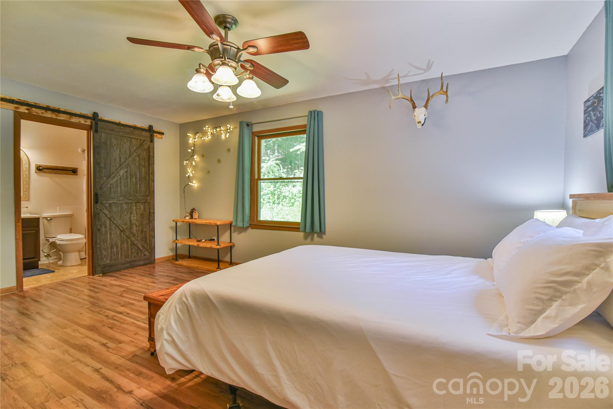 10 Gentry Branch Road Weaverville, NC 28787 - Photo 11 of 33 a bedroom with a bed and a chandelier