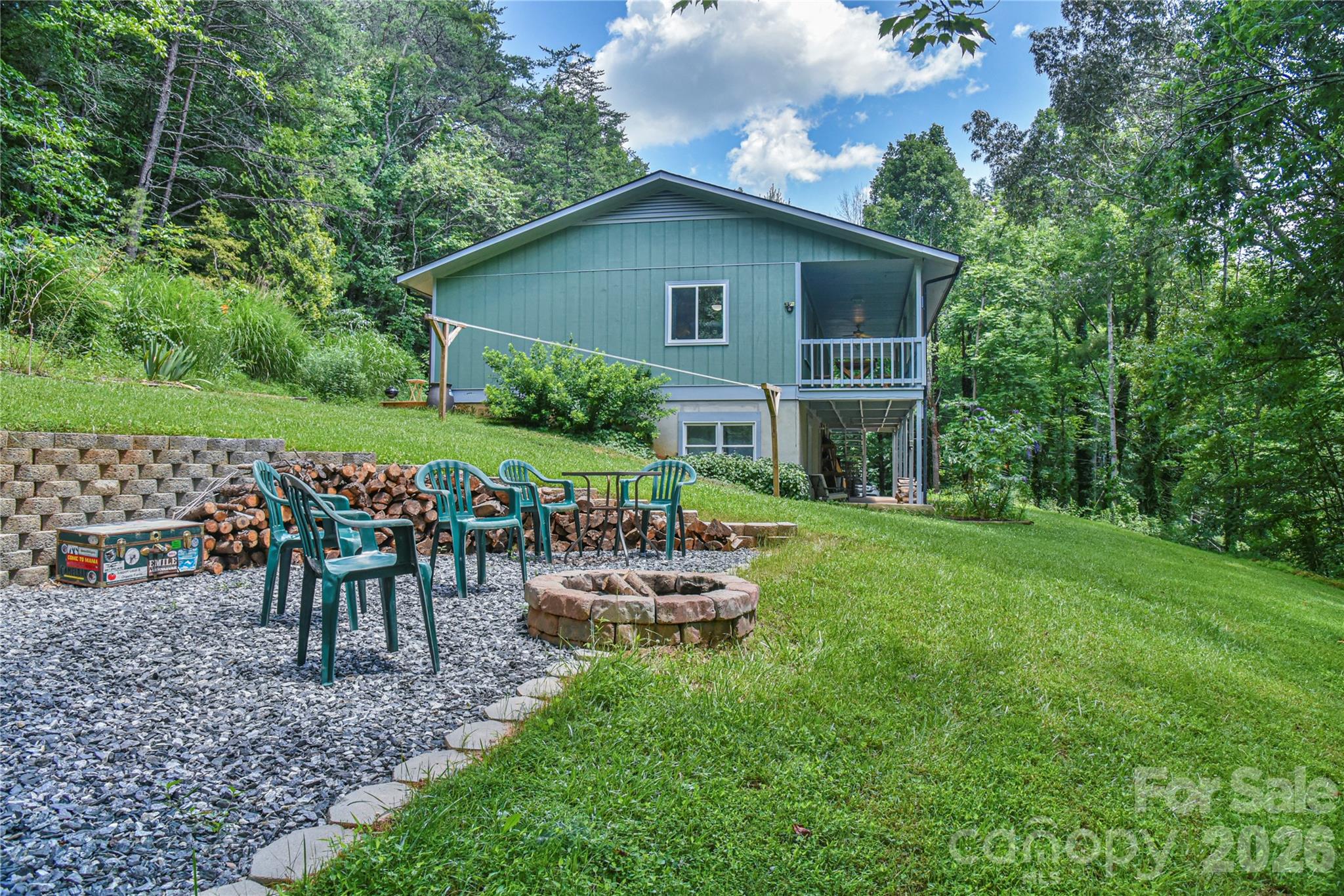 10 Gentry Branch Road Weaverville, NC 28787 - Photo 28 of 33 a view of a house with backyard sitting area and garden
