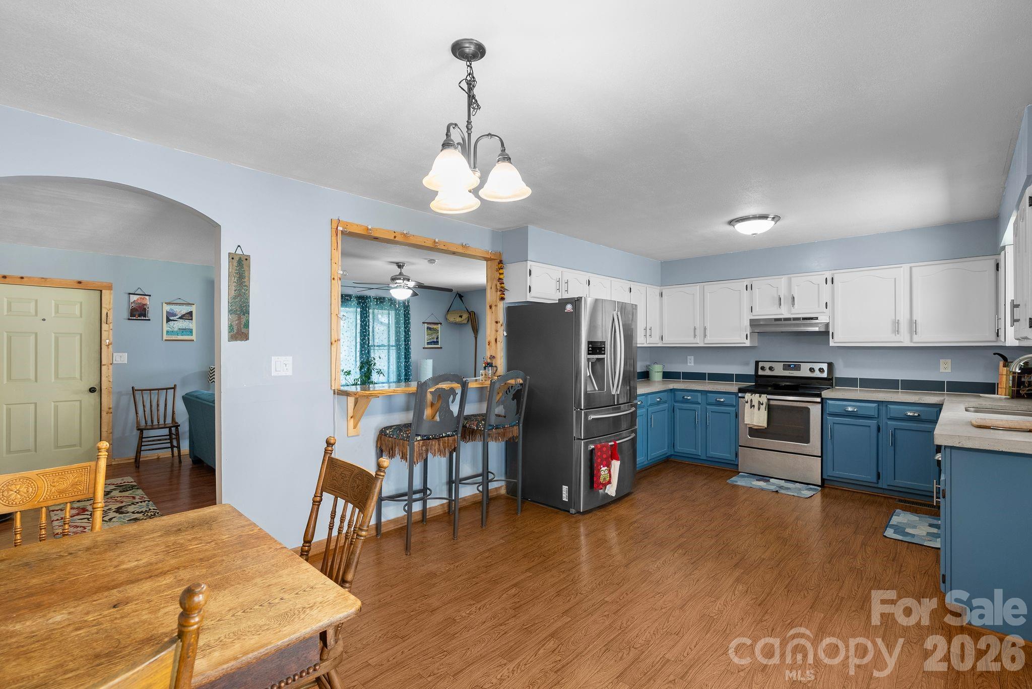 10 Gentry Branch Road Weaverville, NC 28787 - Photo 7 of 33 a kitchen with stainless steel appliances kitchen island granite countertop a refrigerator a stove top oven a sink dishwasher and wooden floor