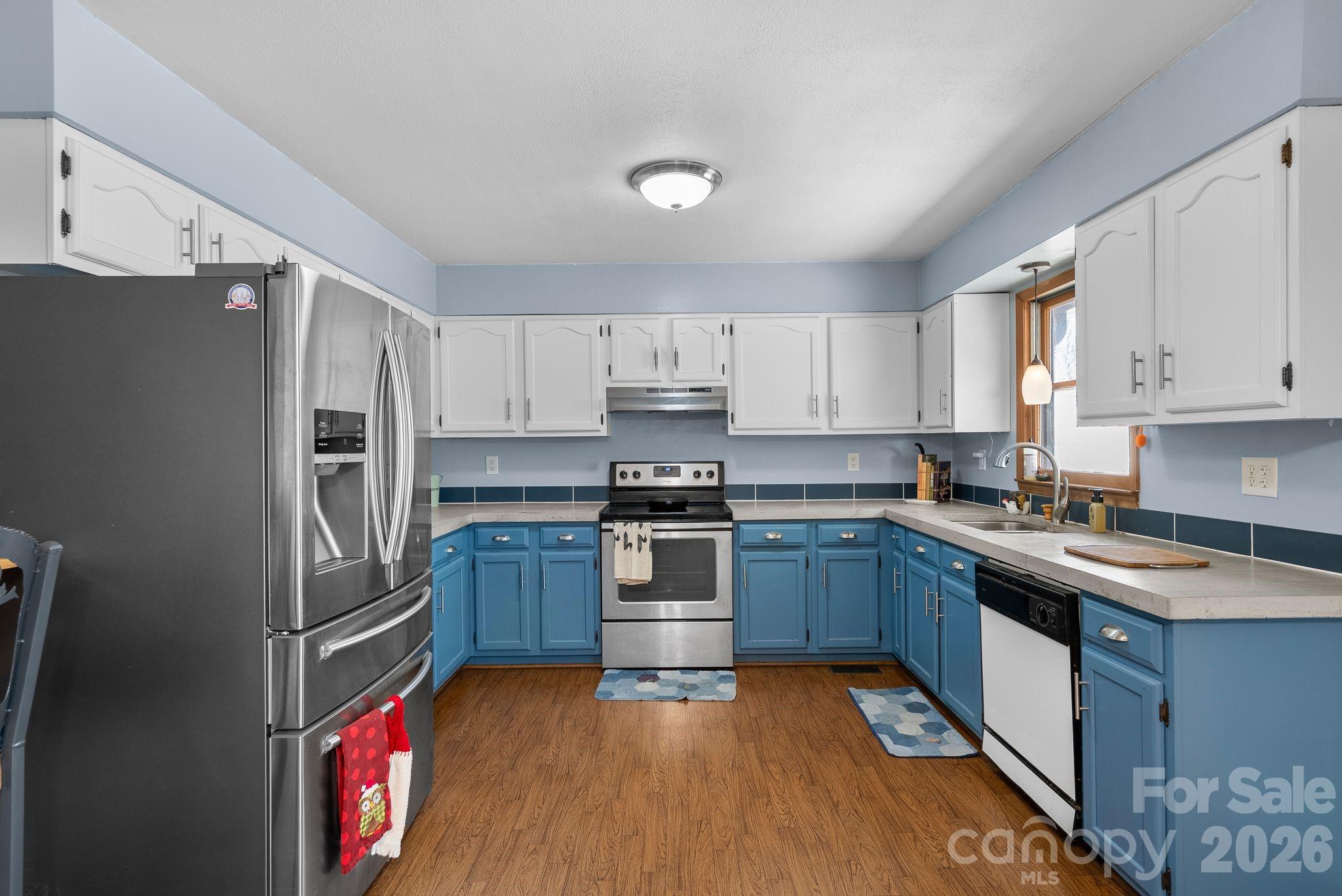 10 Gentry Branch Road Weaverville, NC 28787 - Photo 8 of 33 a kitchen with granite countertop stainless steel appliances and wooden cabinets