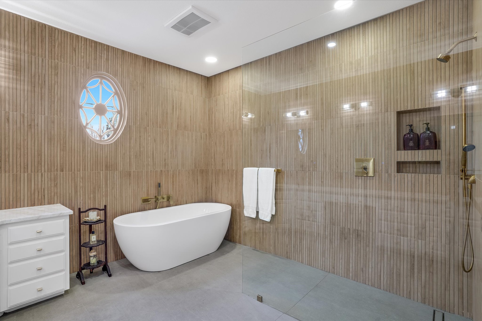 3705 Gilbert Street, Unit B Austin, TX 78703 - Photo 16 of 35 Full bathroom with visible vents, tiled shower, a freestanding tub, tile patterned flooring, and tile walls