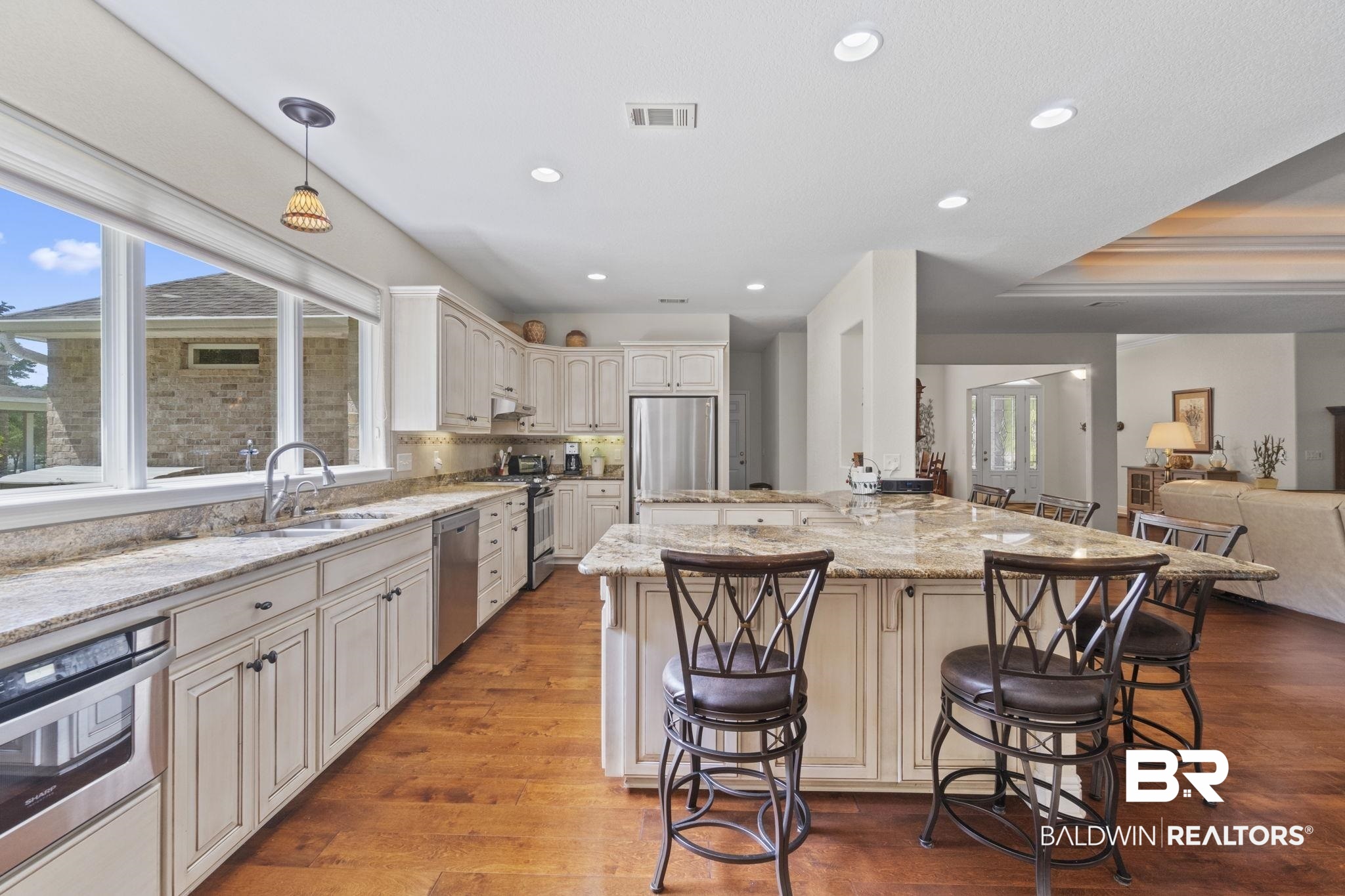 8664 Foxtail Loop Pensacola, FL 32526 - Photo 14 of 64 Kitchen with a sink, stainless steel appliances, a breakfast bar, plenty of natural light, and recessed lighting