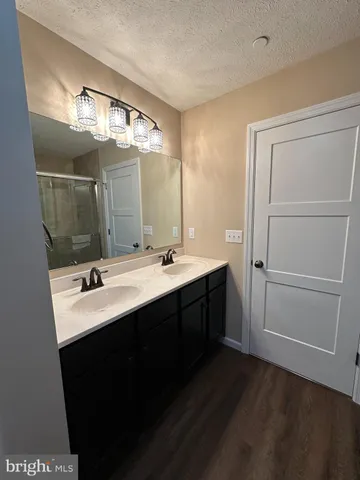 an empty room with a ceiling fan and carpet