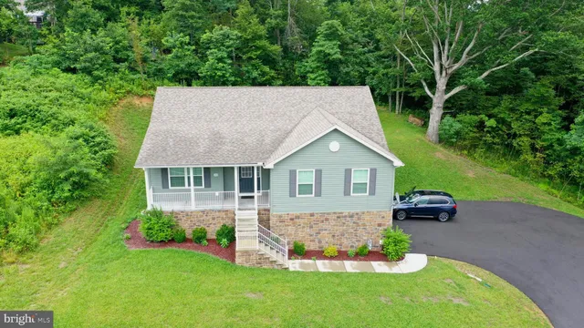 a front view of a house with a garden and yard