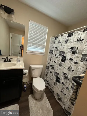 an empty room with a chandelier fan and a window