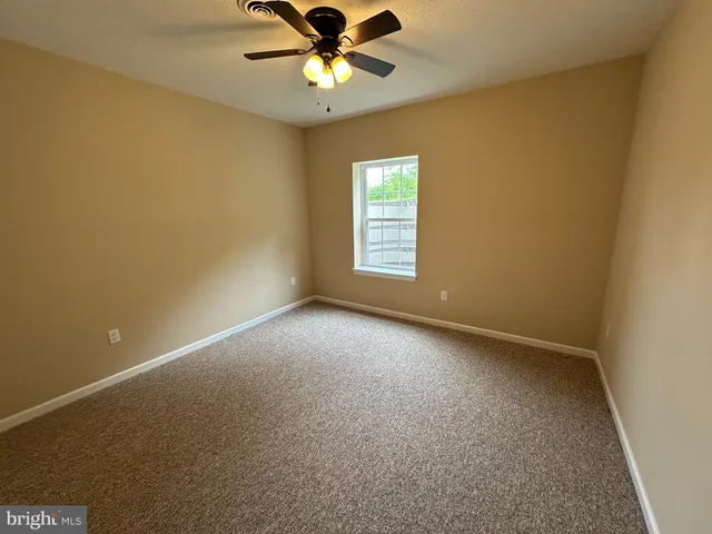 a view of room with a ceiling fan
