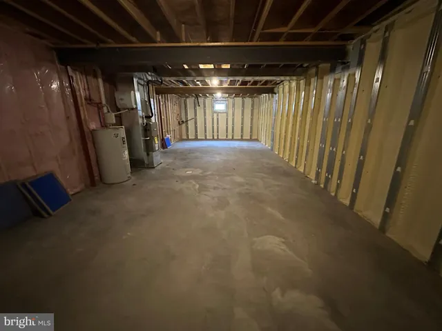 an empty room with wooden floor and entrance