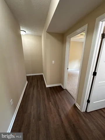 wooden floor in an empty room with a mirror