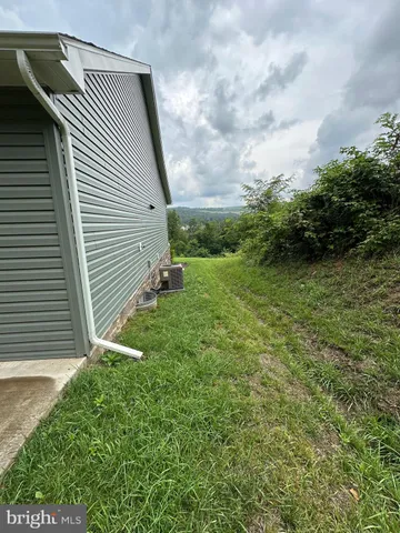 a bathroom with a sink a toilet a mirror and shower