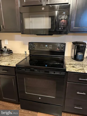 a stove top oven sitting inside of a kitchen