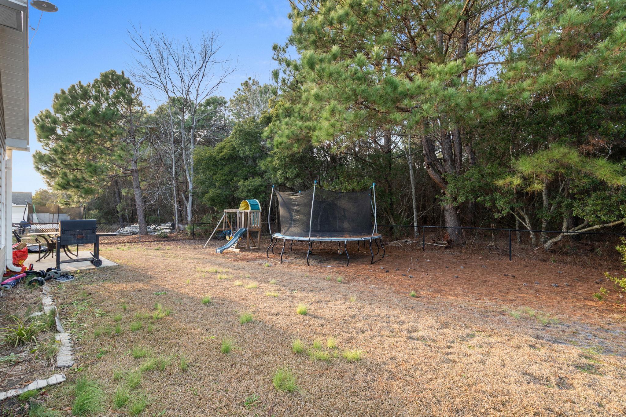 452 West Perry Road Myrtle Beach, SC 29579 - Photo 13 of 26 View of yard featuring a trampoline and a playground