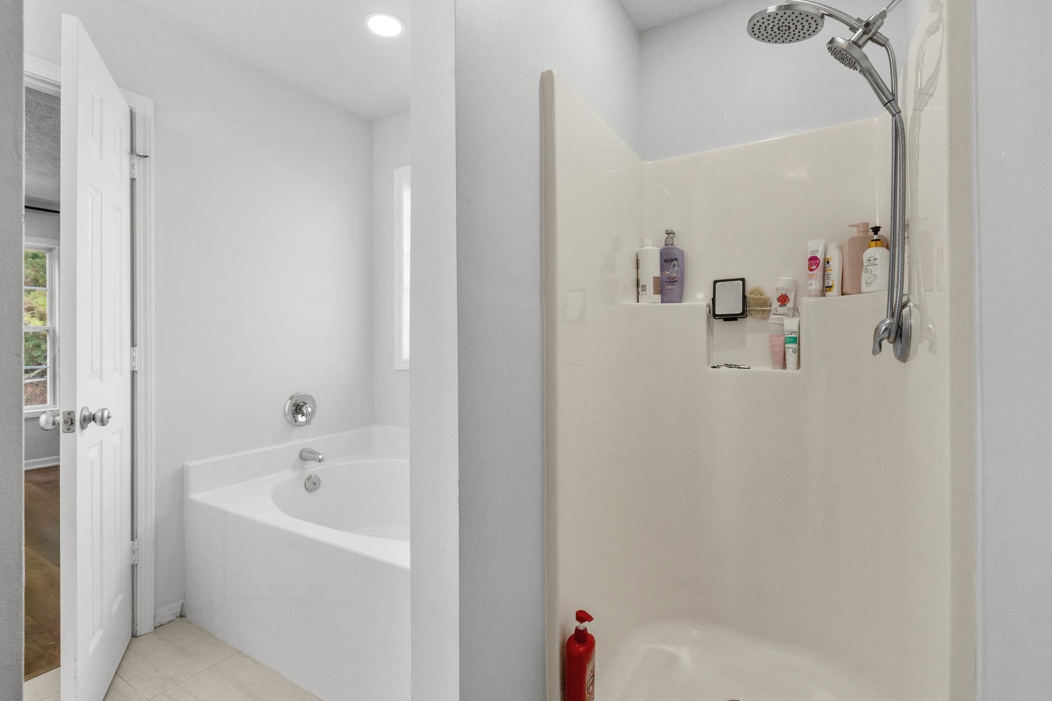 452 West Perry Road Myrtle Beach, SC 29579 - Photo 18 of 26 Full bath featuring a garden tub, a shower stall, and tile patterned floors