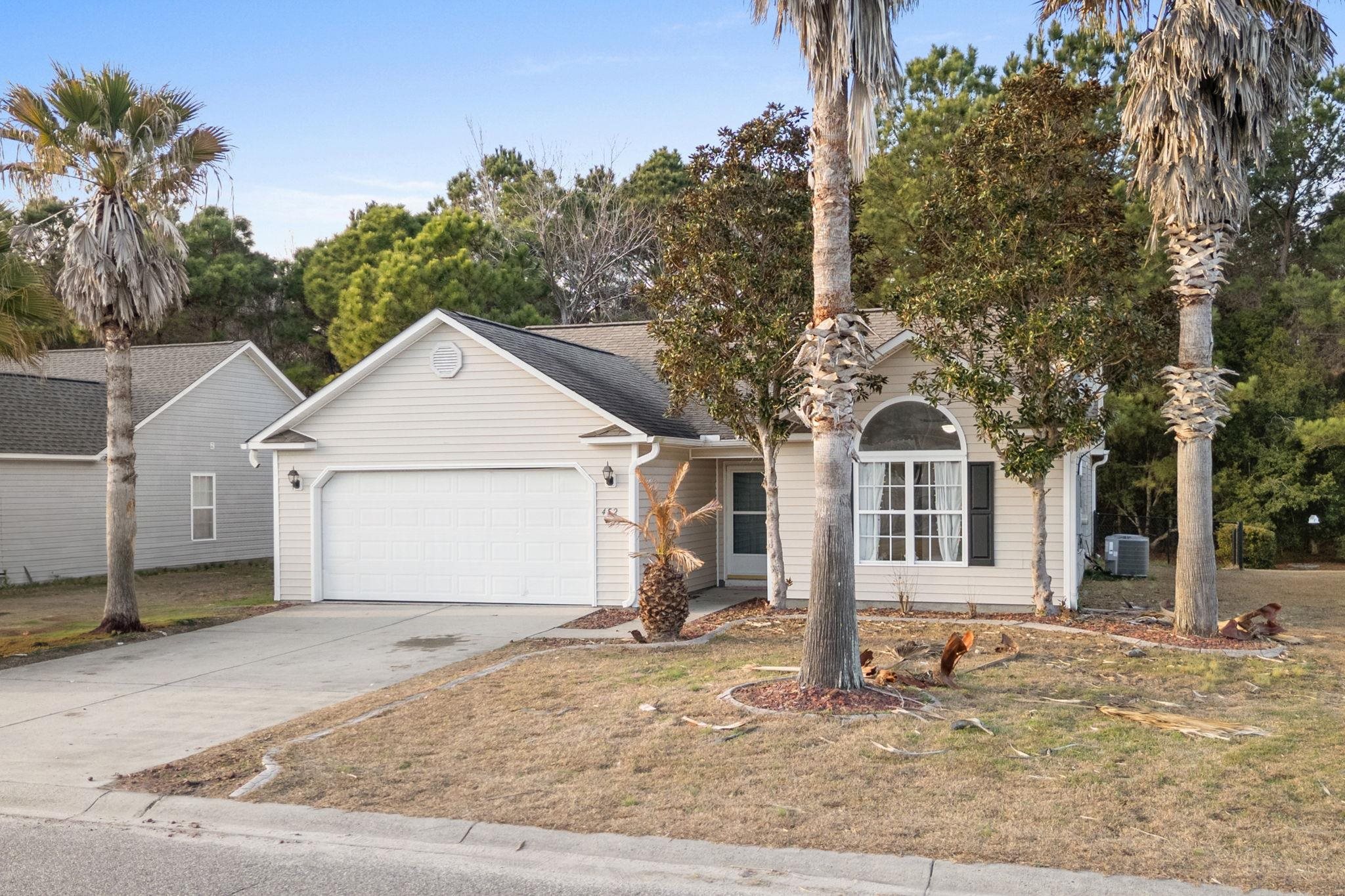 452 West Perry Road Myrtle Beach, SC 29579 - Photo 2 of 26 View of front of house featuring concrete driveway, a garage, and a front yard
