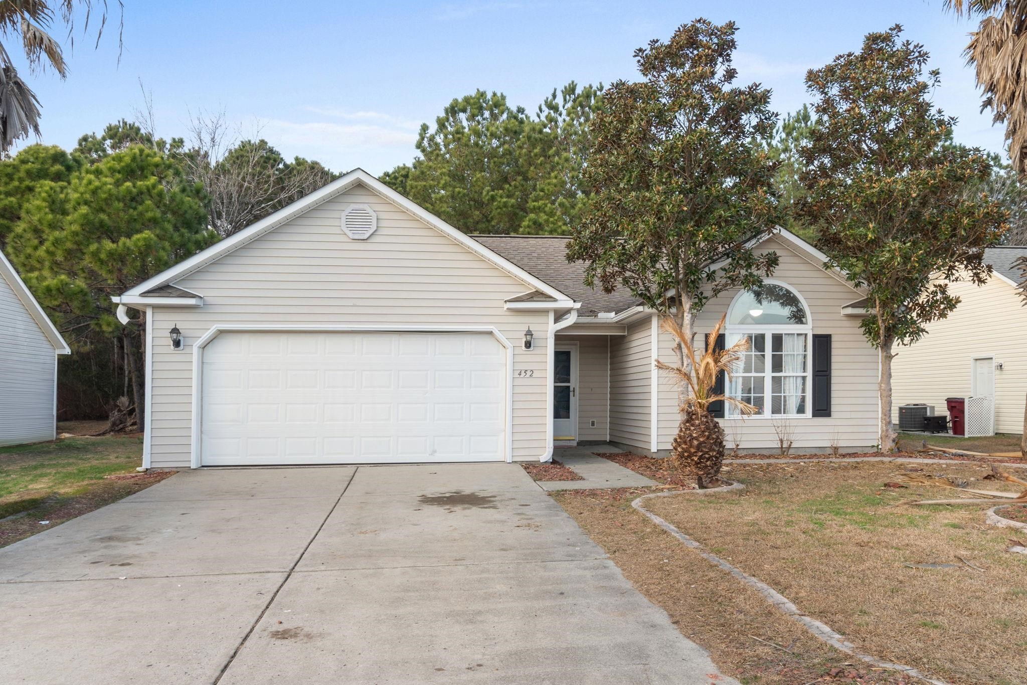452 West Perry Road Myrtle Beach, SC 29579 - Photo 23 of 26 Ranch-style home featuring concrete driveway, an attached garage, roof with shingles, and a front yard