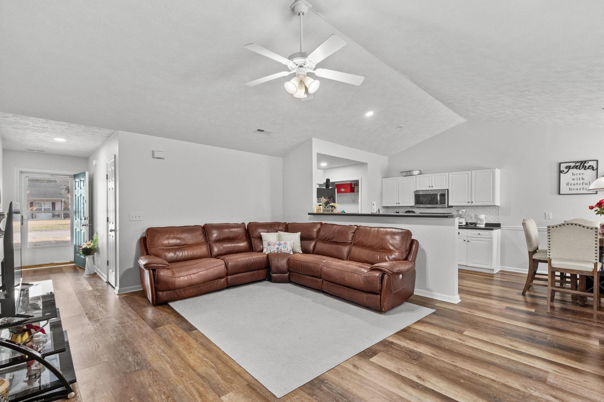 452 West Perry Road Myrtle Beach, SC 29579 - Photo 4 of 26 Living room with vaulted ceiling, dark wood-style floors, and ceiling fan
