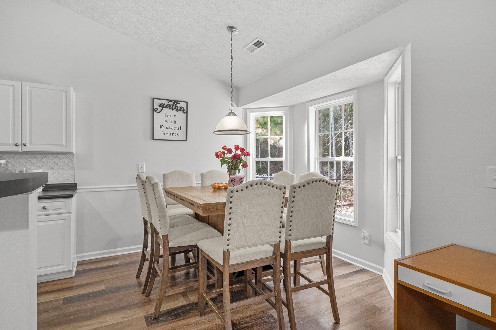452 West Perry Road Myrtle Beach, SC 29579 - Photo 6 of 26 Dining room featuring lofted ceiling, dark wood-style floors, and a textured ceiling