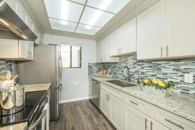 2601 Willowbrook Lane, Unit 6 Aptos, CA 95003 - Photo 23 of 43 a kitchen with granite countertop a sink a stove and cabinets
