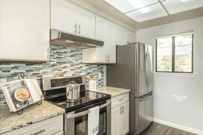 2601 Willowbrook Lane, Unit 6 Aptos, CA 95003 - Photo 24 of 43 a kitchen with granite countertop a refrigerator stove and sink