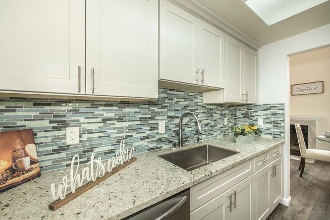 2601 Willowbrook Lane, Unit 6 Aptos, CA 95003 - Photo 25 of 43 a kitchen with granite countertop a sink and a stove
