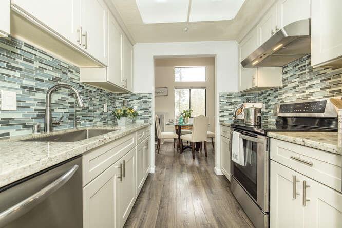 2601 Willowbrook Lane, Unit 6 Aptos, CA 95003 - Photo 26 of 43 a kitchen with stainless steel appliances granite countertop a stove and a wooden floors