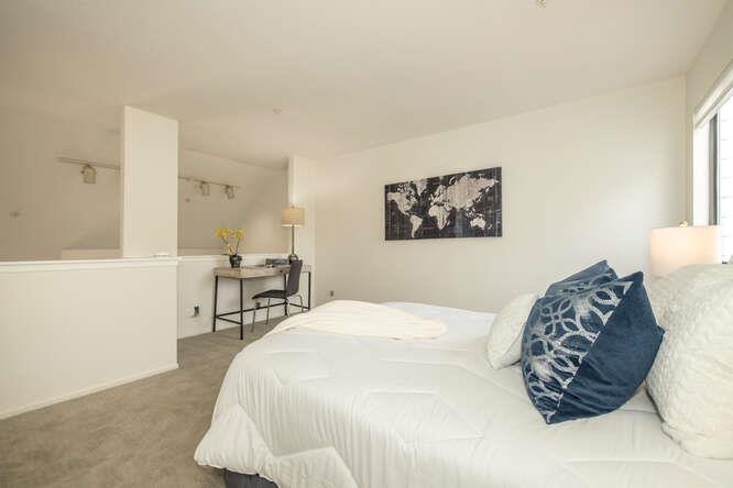 2601 Willowbrook Lane, Unit 6 Aptos, CA 95003 - Photo 40 of 43 a bedroom with a bed a table and chair