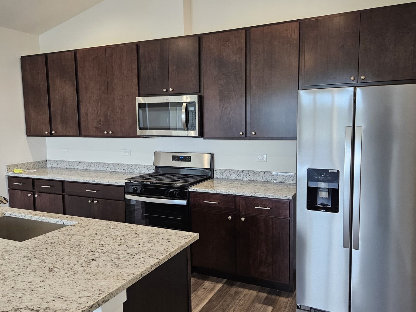 31 Apollo Court Tinley Park, IL 60477 - Photo 2 of 7 a kitchen with a stove a microwave and refrigerator