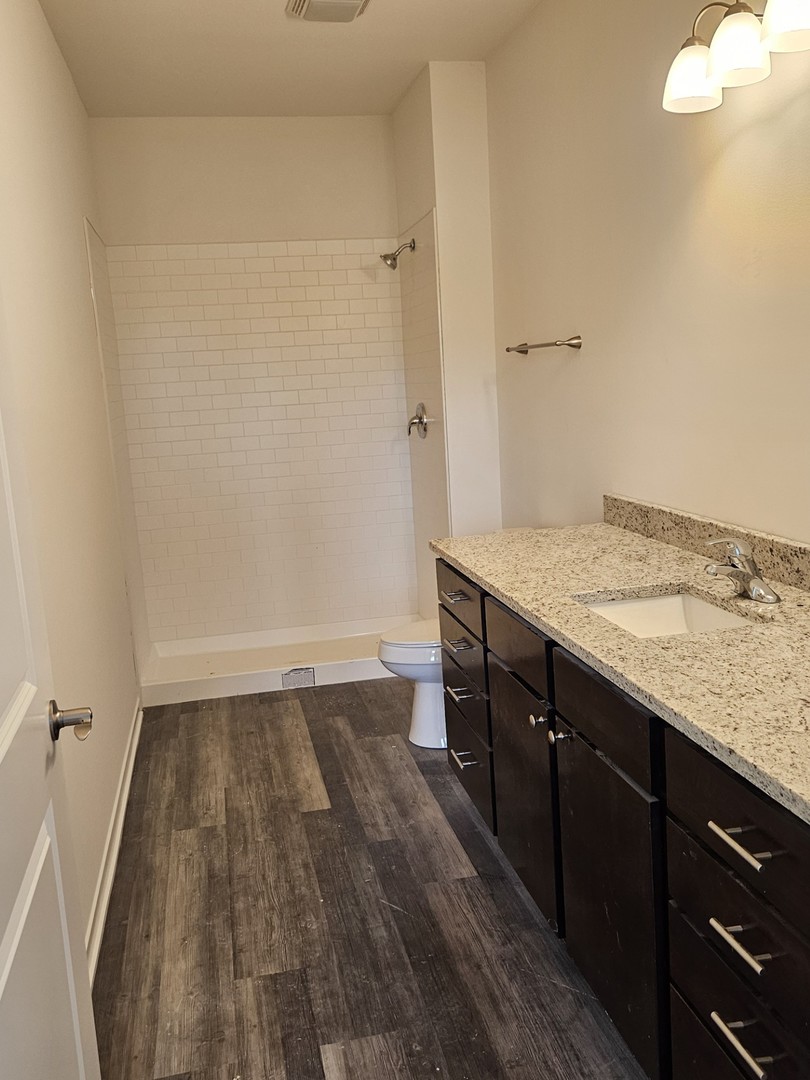 31 Apollo Court Tinley Park, IL 60477 - Photo 4 of 7 a kitchen with a sink and wooden floor