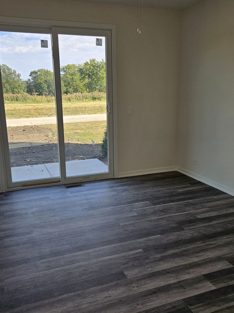 31 Apollo Court Tinley Park, IL 60477 - Photo 6 of 7 a view of an empty room with wooden floor and a window