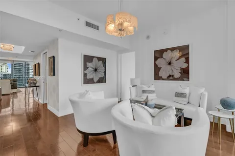 a living room with furniture wooden floor and dining table