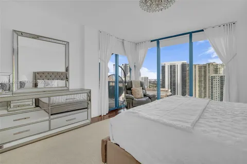 a bedroom with a bed and large window