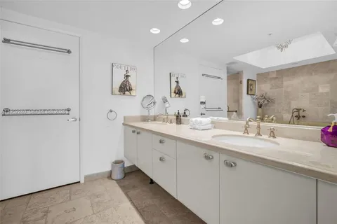 a living room with furniture a lamp and a potted plant